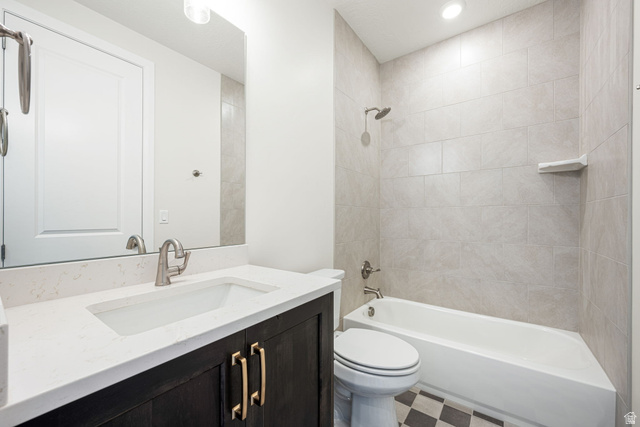 684 West High Tide Place, Unit 131 St. George, UT 84790 - Photo 18 of 27 Bathroom featuring a dark wood-finish vanity with gold-tone hardware, white countertop with integrated sink, and brushed nickel faucet