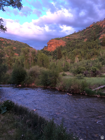 13581 13581st Huntsville, UT 84317 - Photo 1 of 11 River frontage featuring clear waters, natural rock formations, and abundant mature trees
