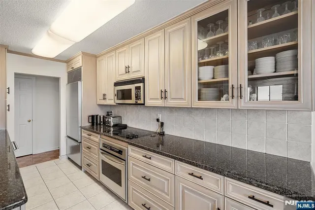 a bathroom with a granite countertop sink mirror and toilet