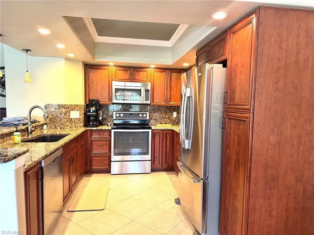 a kitchen with stainless steel appliances a refrigerator and a sink
