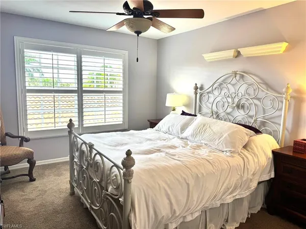 a bed sitting in a bedroom next to a window