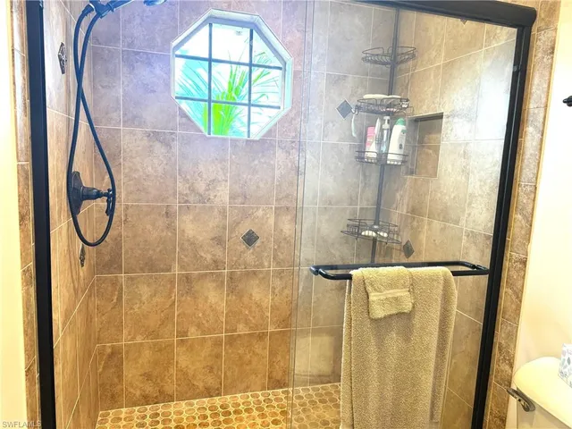a bathroom with a mirror and a shower
