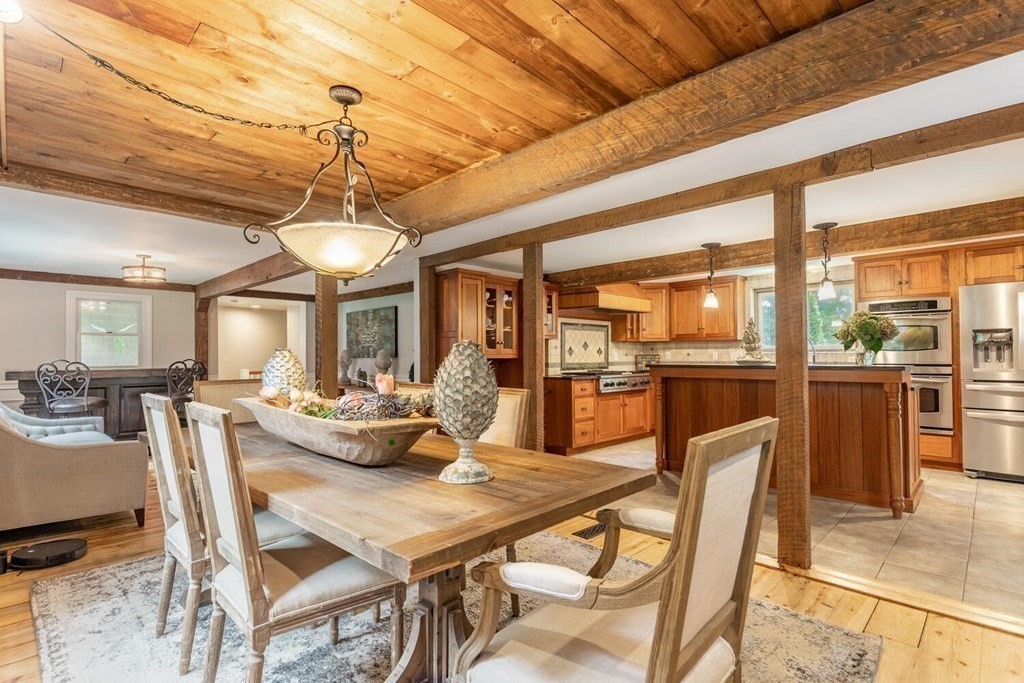 373 Ipswich Road Boxford, MA 01921 - Photo 12 of 37 a dining room with furniture a chandelier and fireplace