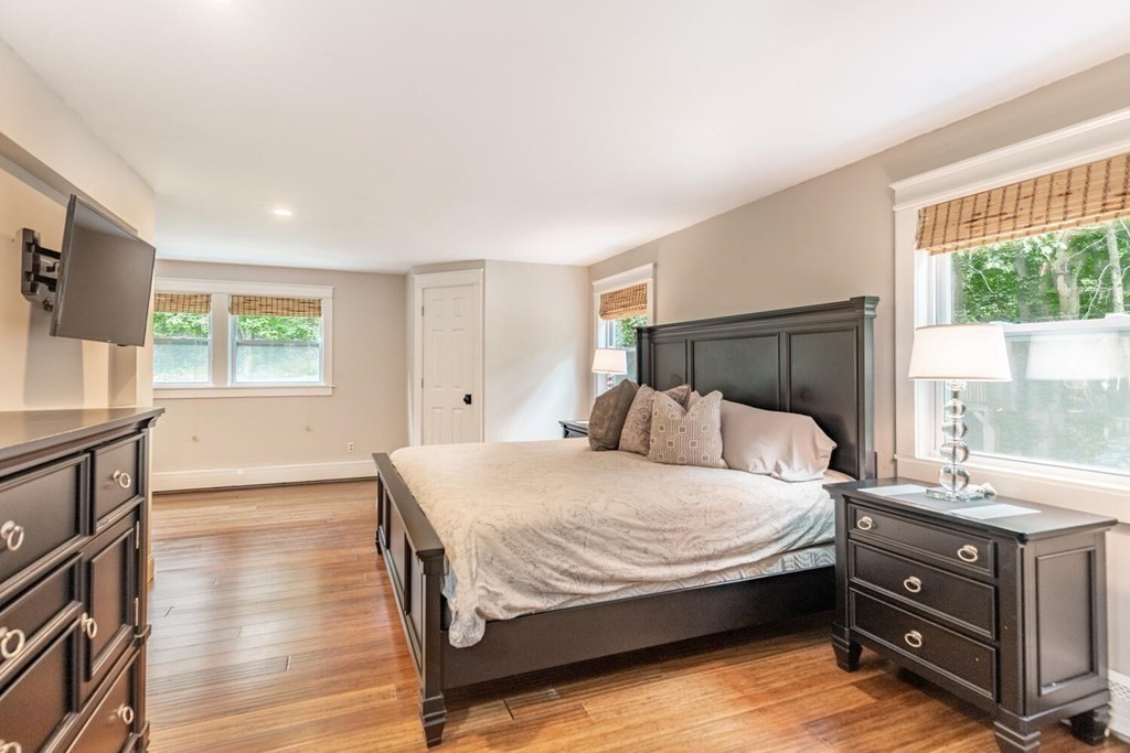 373 Ipswich Road Boxford, MA 01921 - Photo 21 of 37 a bedroom with a bed and wooden floor
