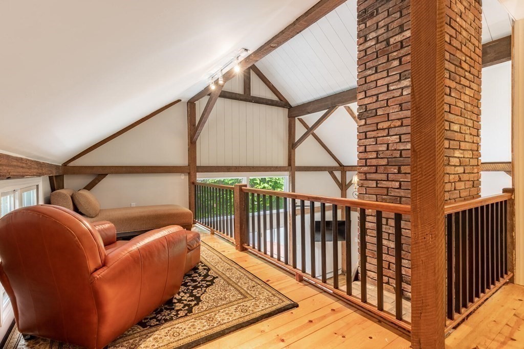 373 Ipswich Road Boxford, MA 01921 - Photo 22 of 37 a balcony with furniture and a book shelf