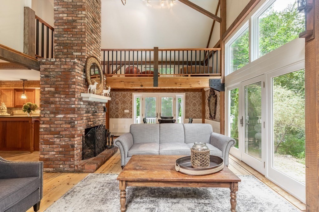 373 Ipswich Road Boxford, MA 01921 - Photo 5 of 37 a living room with furniture a fireplace and a floor to ceiling window