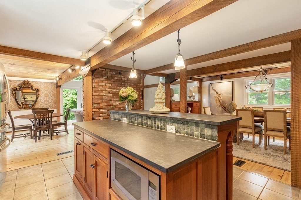 373 Ipswich Road Boxford, MA 01921 - Photo 8 of 37 a view of a kitchen with kitchen island stainless steel appliances a table and chairs in it