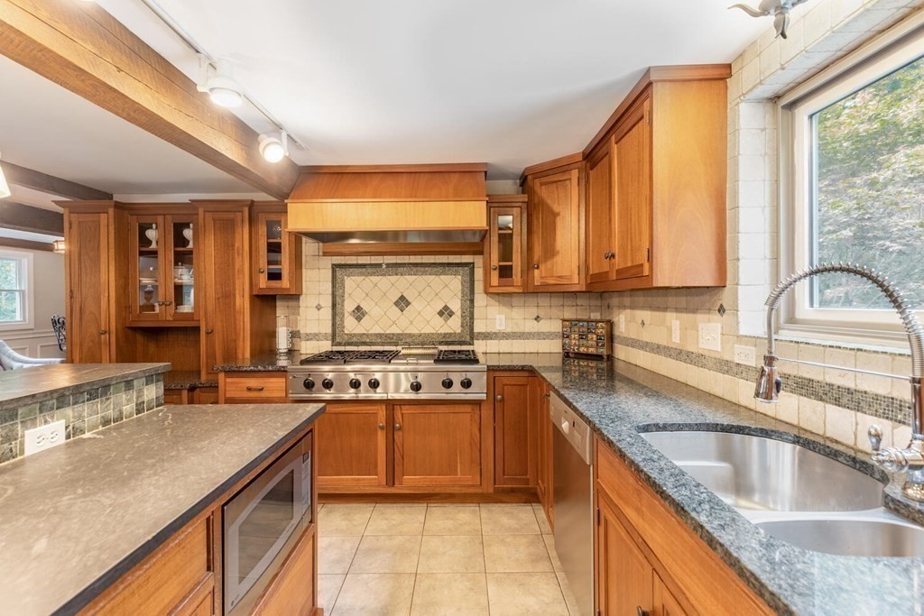 373 Ipswich Road Boxford, MA 01921 - Photo 10 of 37 a kitchen with stainless steel appliances granite countertop a sink stove and cabinets