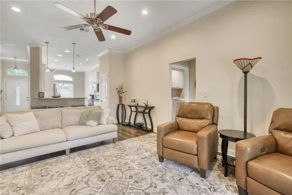 a living room with furniture and a wooden floor