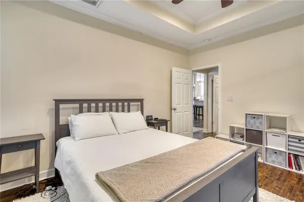 a bedroom with a large bed and a chandelier