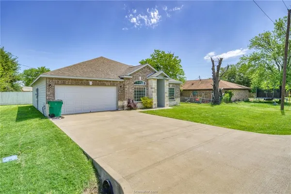 a front view of house with yard and green space