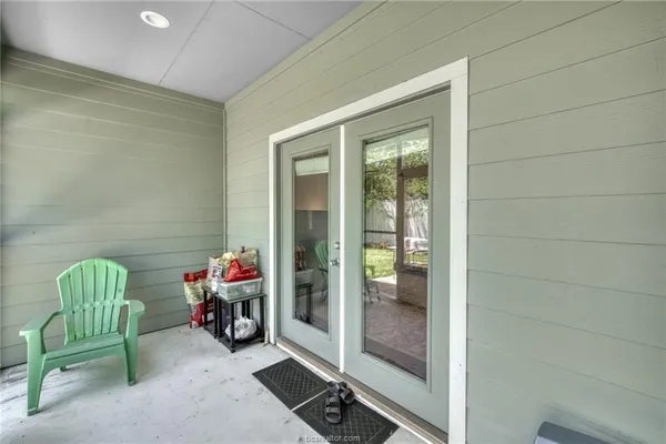 a backyard of a house with table and chairs