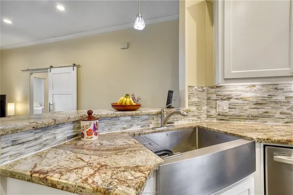 a kitchen with a sink and a stove top oven