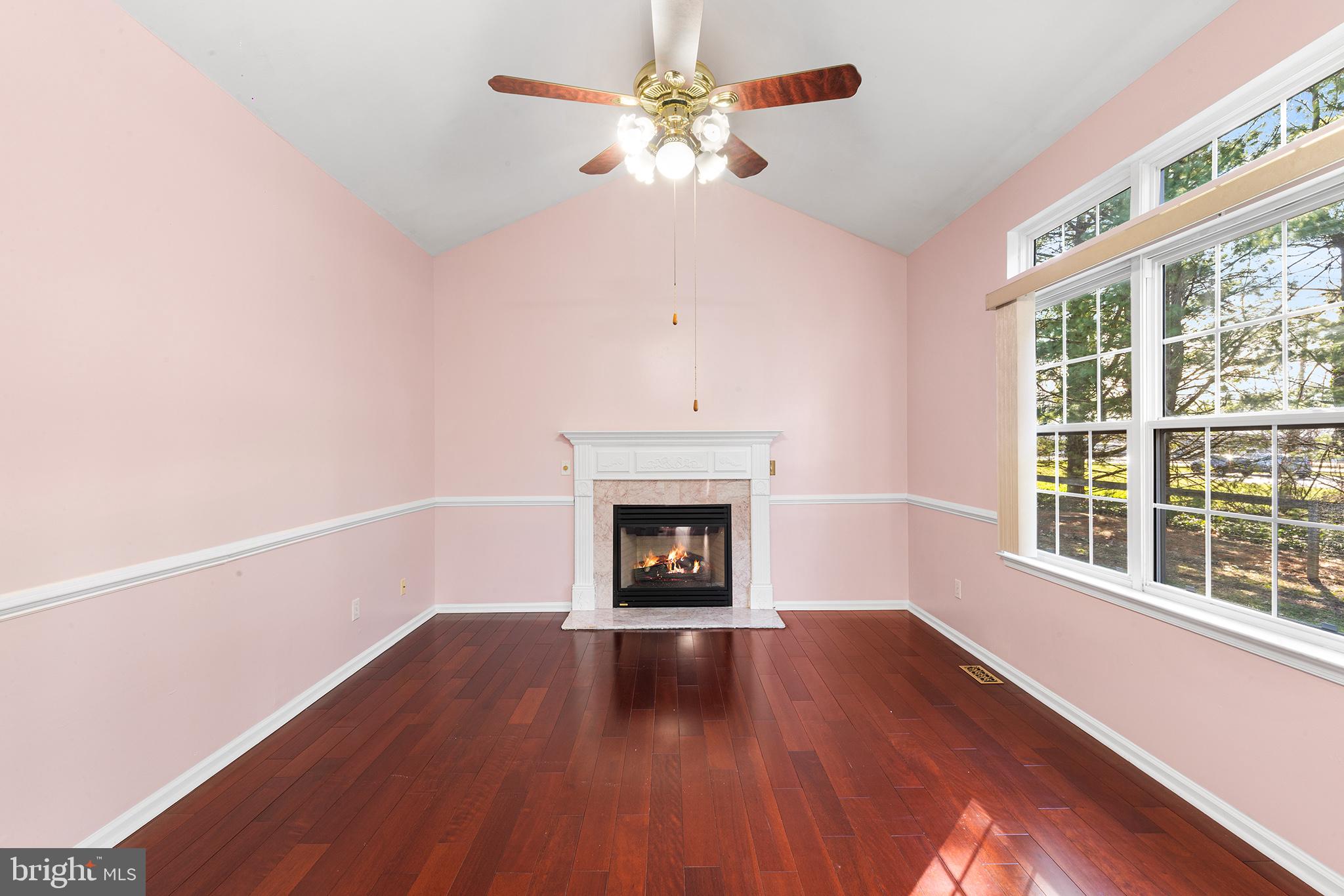 6 Sunset Hollow Road West Chester, PA 19380 - Photo 16 of 46 a view of an empty room with wooden floor fireplace and a window