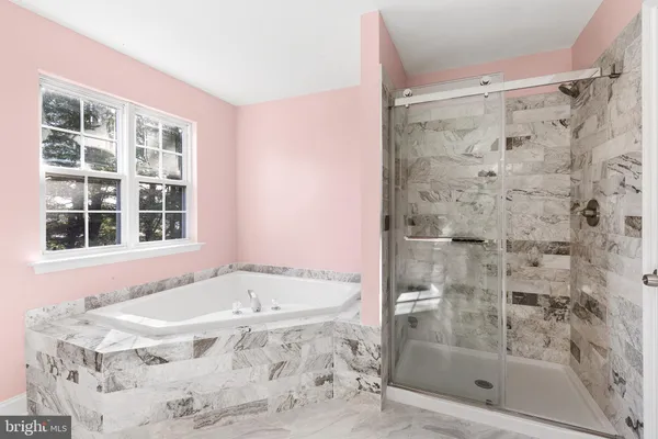 a bath tub sitting next to a shower