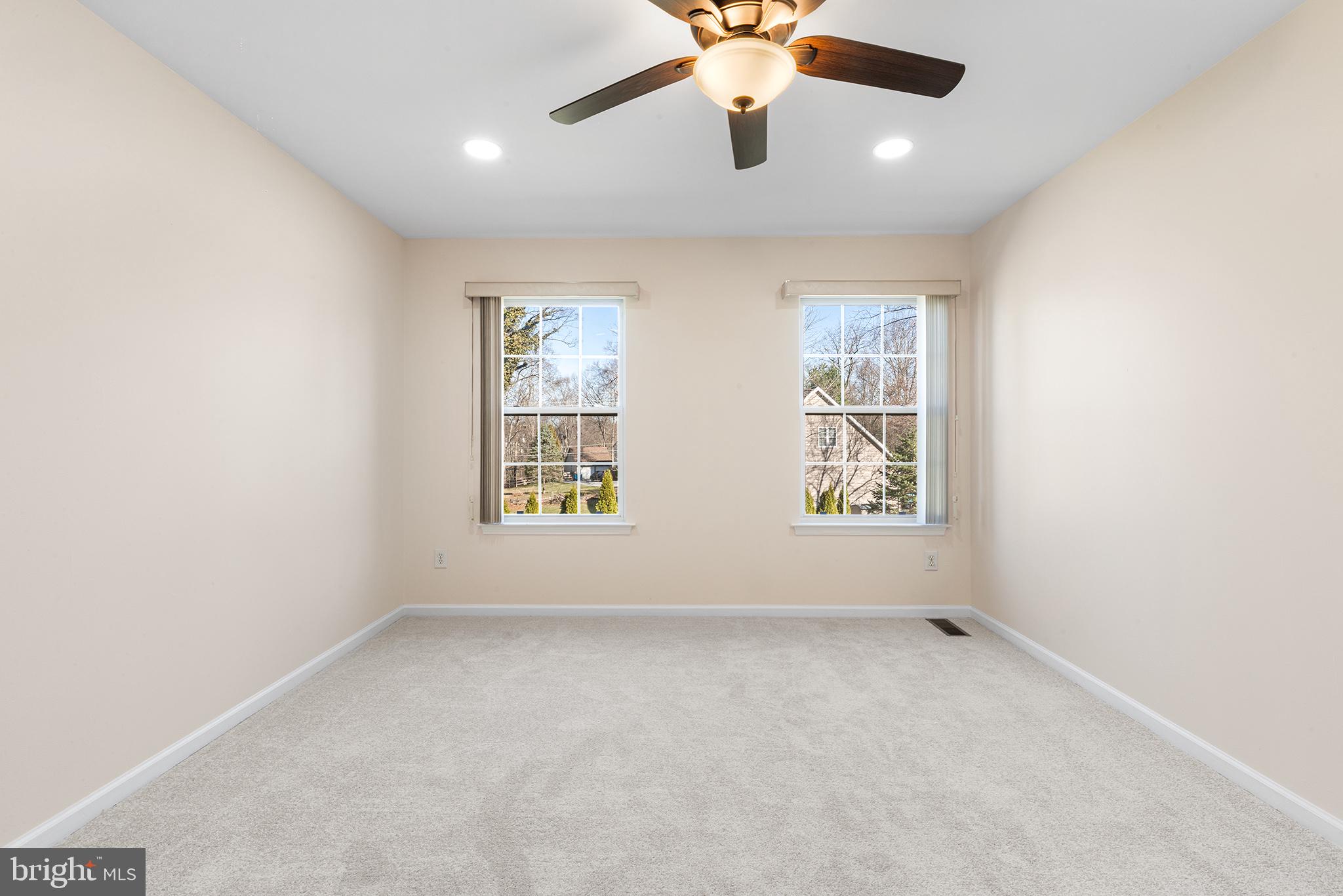 6 Sunset Hollow Road West Chester, PA 19380 - Photo 29 of 46 an empty room with windows and chandelier fan