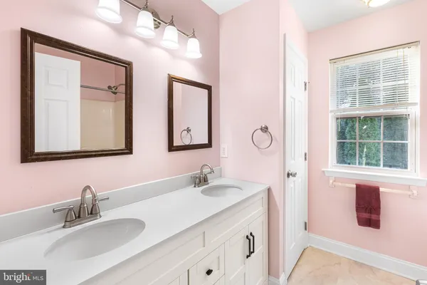 a bathroom with a sink vanity and mirror