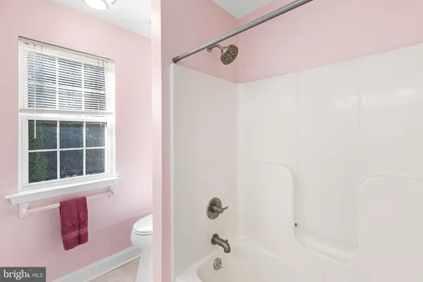 a bathroom with a bathtub and shower
