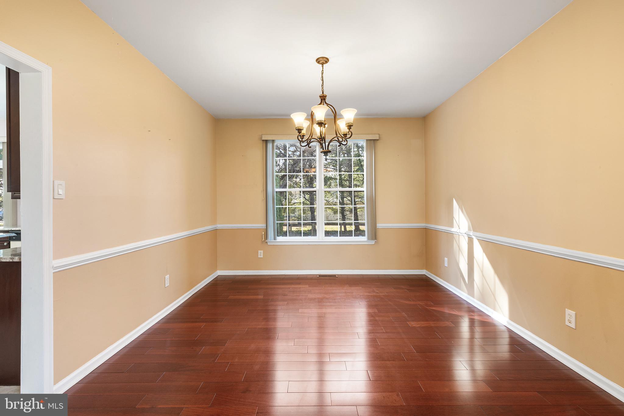 6 Sunset Hollow Road West Chester, PA 19380 - Photo 6 of 46 a view of an empty room with wooden floor and a window