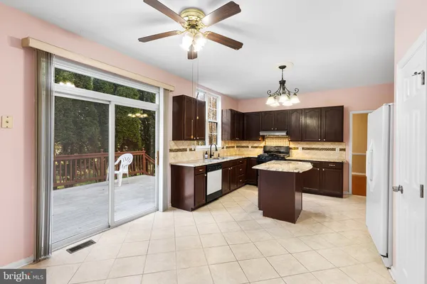 a large kitchen with a large counter top appliances and cabinets