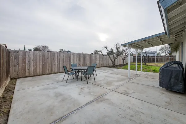 a view of a house with a yard and sitting area