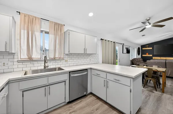 a kitchen with a sink stove and cabinets
