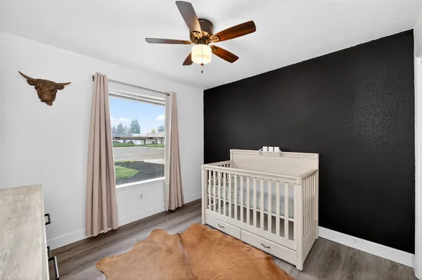 a bedroom with a bed and a large window