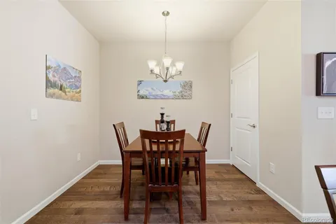a view of a dining room with furniture and chandelier