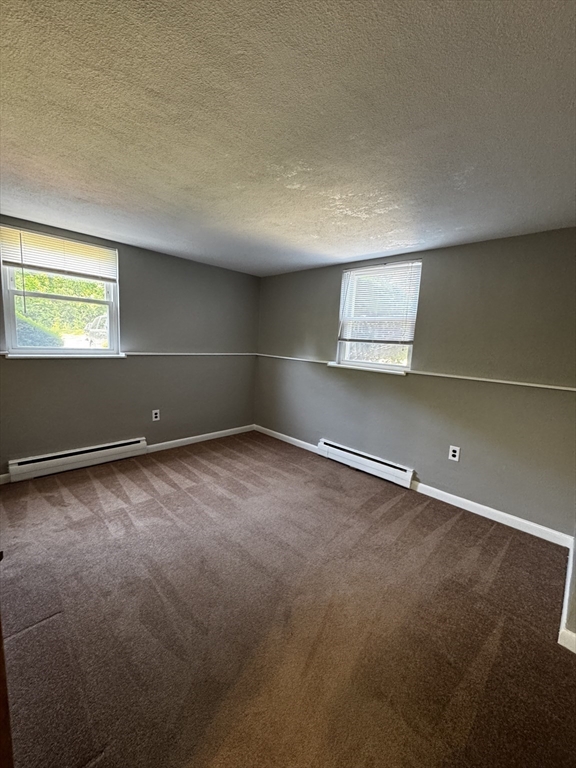 30 Worthen Street, Unit C4 Chelmsford, MA 01824 - Photo 6 of 8 an empty room with a empty space and a window