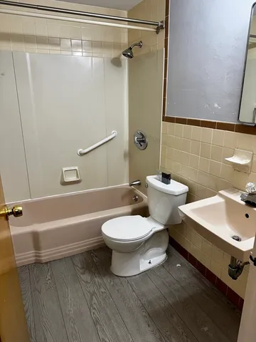 a bathroom with a toilet sink and shower