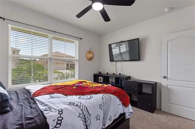 a bedroom with a bed and a large window