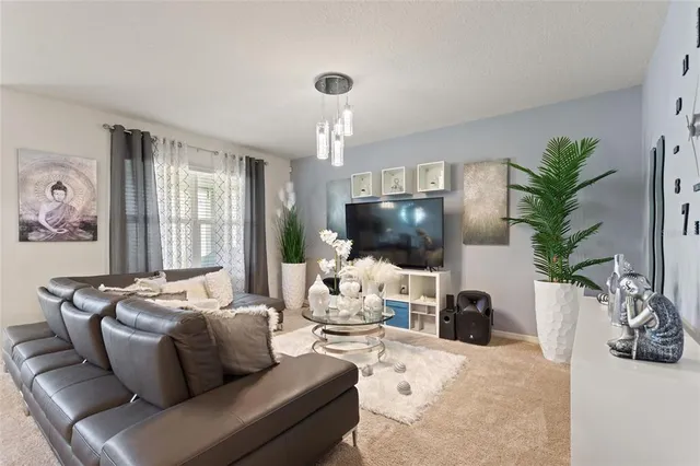a living room with furniture a large window and a flat screen tv