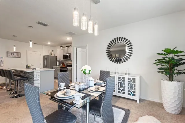 a dining room with furniture and a chandelier