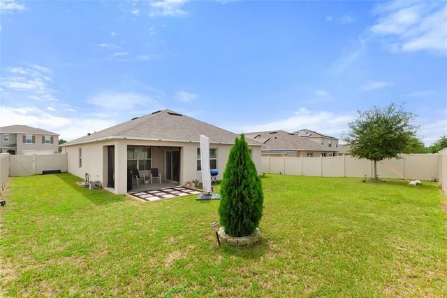a view of a house with a yard and sitting area