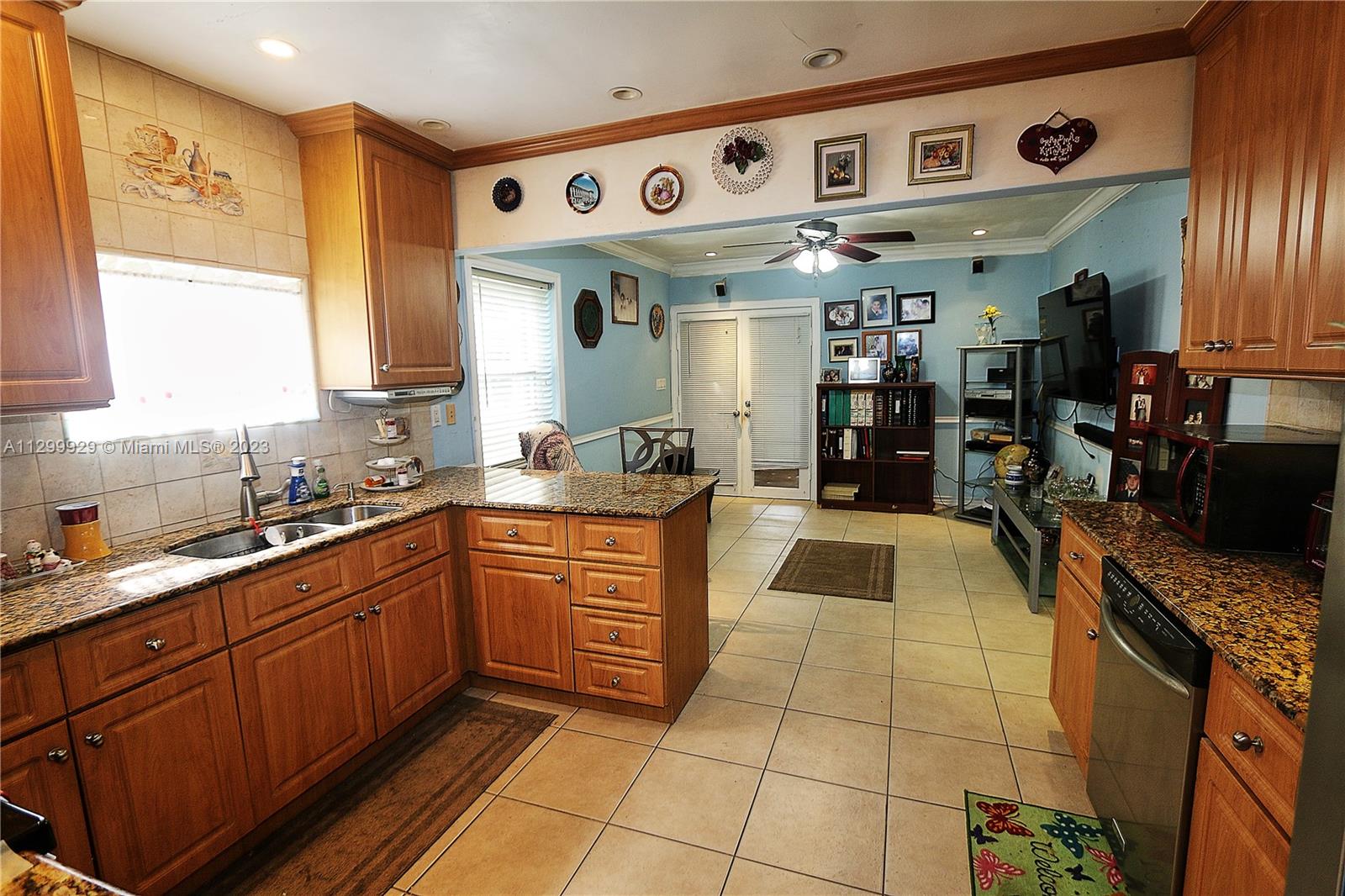 842 Southwest 89th Avenue, Unit A Miami, FL 33174 - Photo 11 of 34 a kitchen with stainless steel appliances granite countertop a sink and cabinets