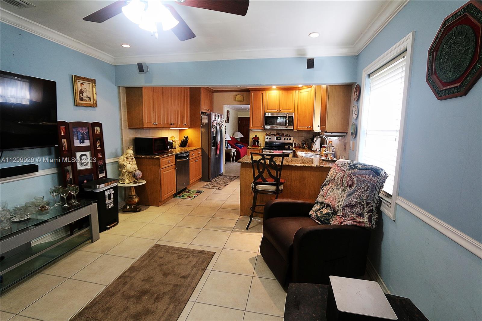842 Southwest 89th Avenue, Unit A Miami, FL 33174 - Photo 16 of 34 a living room with furniture and a flat screen tv
