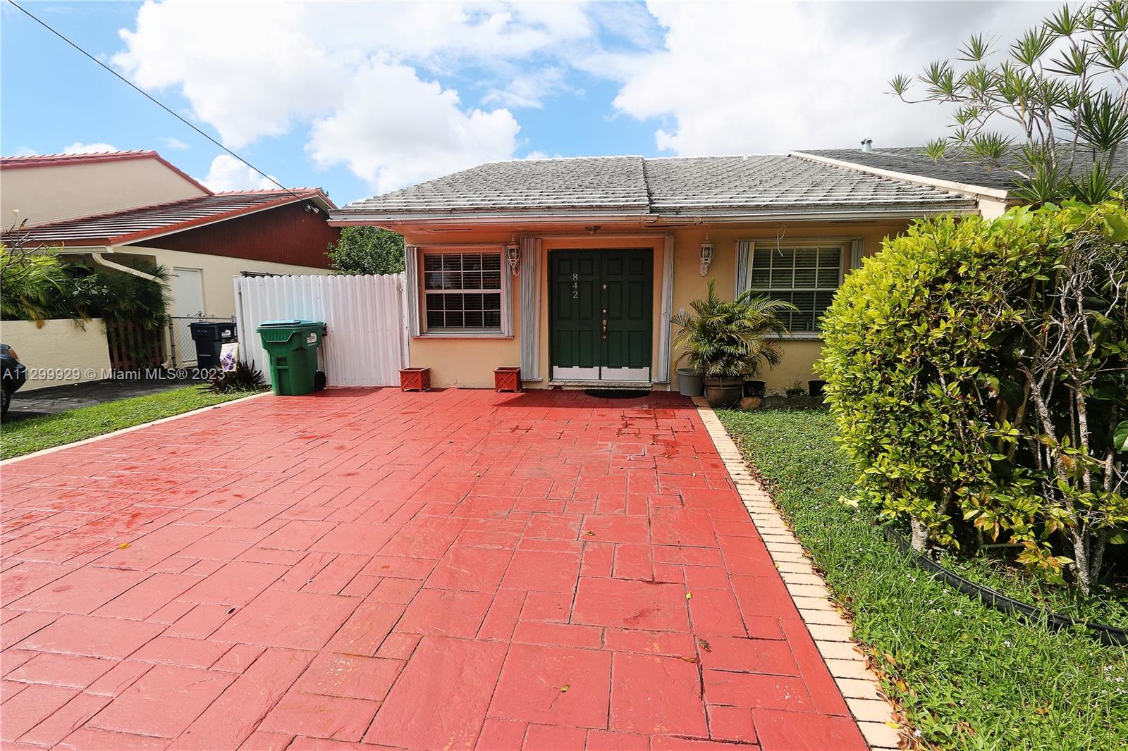 842 Southwest 89th Avenue, Unit A Miami, FL 33174 - Photo 2 of 34 a front view of a house with a yard and potted plants
