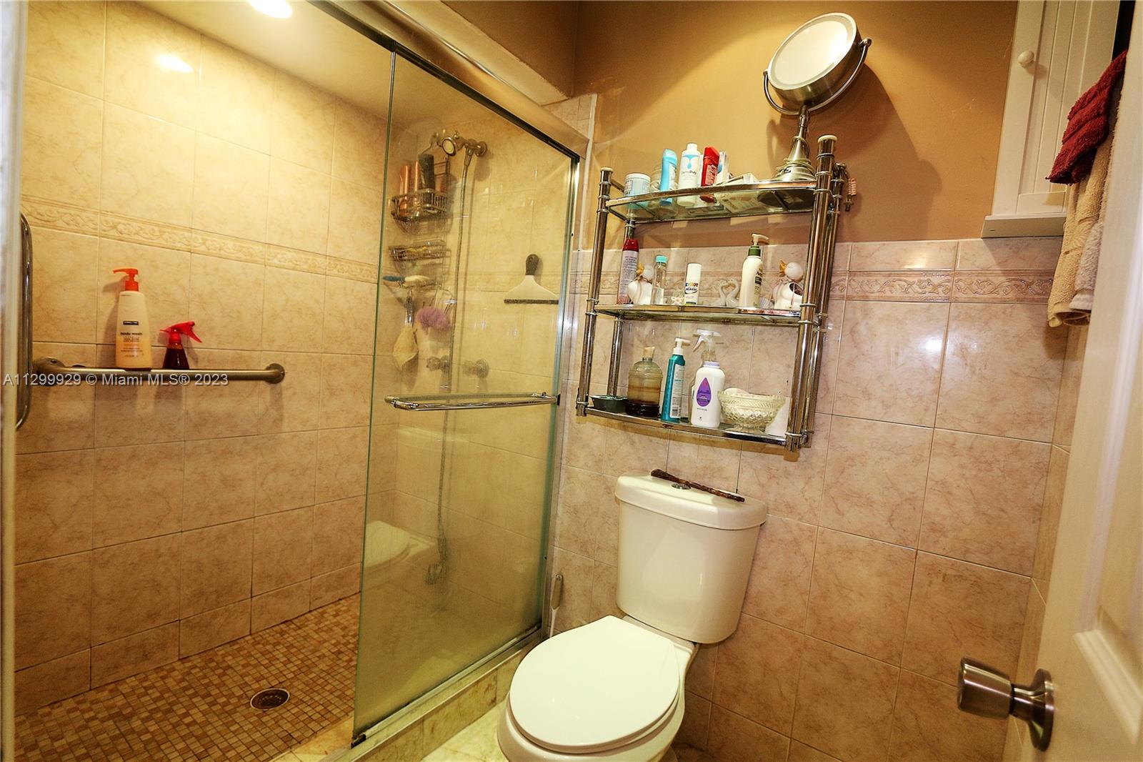 842 Southwest 89th Avenue, Unit A Miami, FL 33174 - Photo 21 of 34 a bathroom with a toilet and a shower
