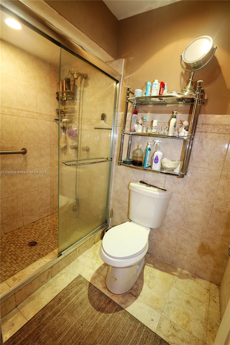 842 Southwest 89th Avenue, Unit A Miami, FL 33174 - Photo 22 of 34 a bathroom with a toilet and a shower