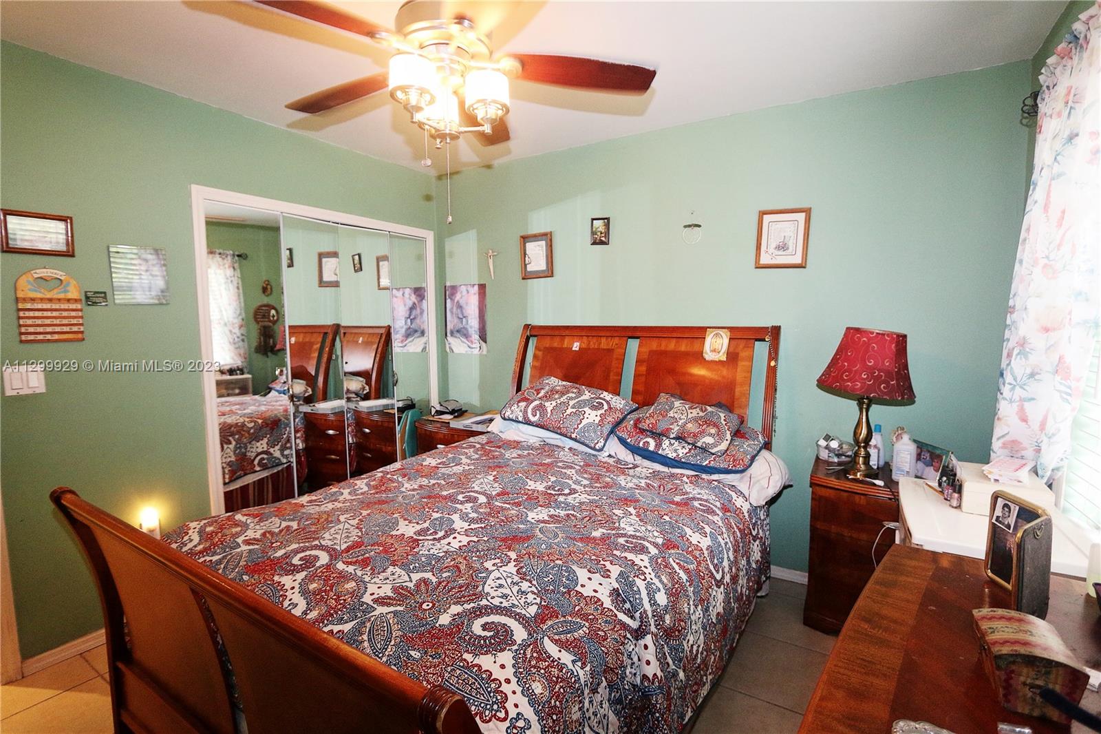 842 Southwest 89th Avenue, Unit A Miami, FL 33174 - Photo 26 of 34 a bed sitting in a bedroom next to a window