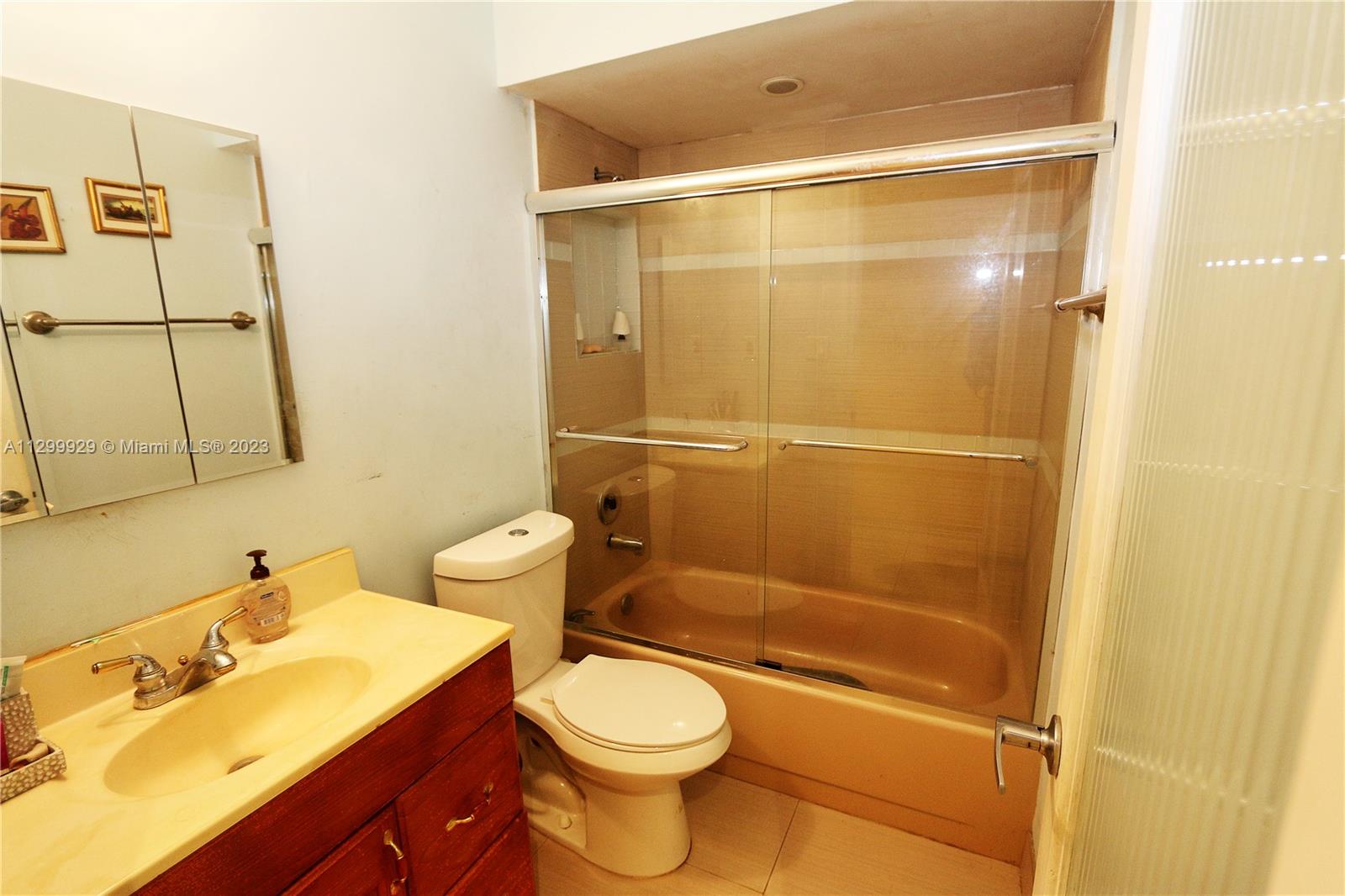842 Southwest 89th Avenue, Unit A Miami, FL 33174 - Photo 27 of 34 a bathroom with a sink mirror vanity and toilet