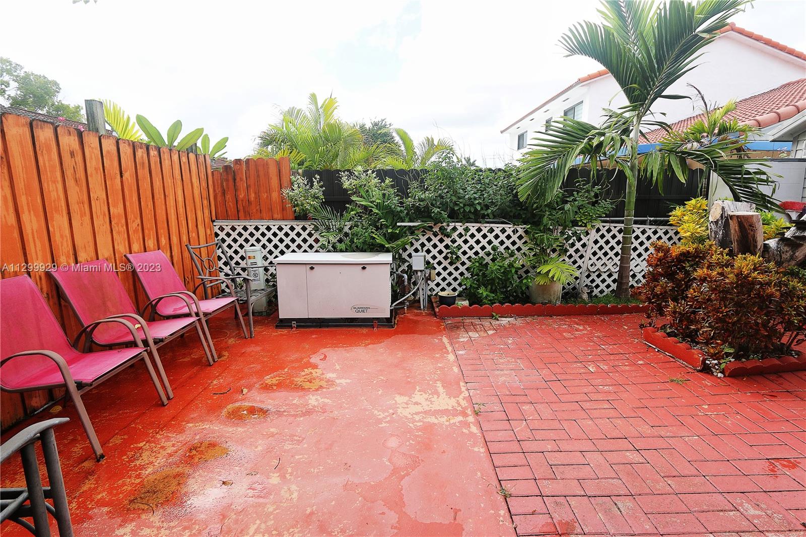 842 Southwest 89th Avenue, Unit A Miami, FL 33174 - Photo 29 of 34 a backyard of a house with chairs and a fire pit