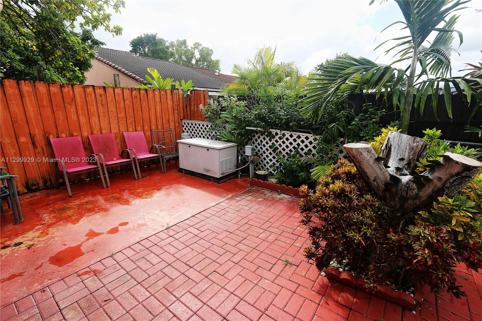 842 Southwest 89th Avenue, Unit A Miami, FL 33174 - Photo 30 of 34 a view of a backyard with lawn chairs and a potted plant