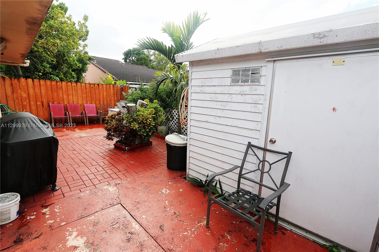 842 Southwest 89th Avenue, Unit A Miami, FL 33174 - Photo 31 of 34 a view of a backyard with furniture and a grill