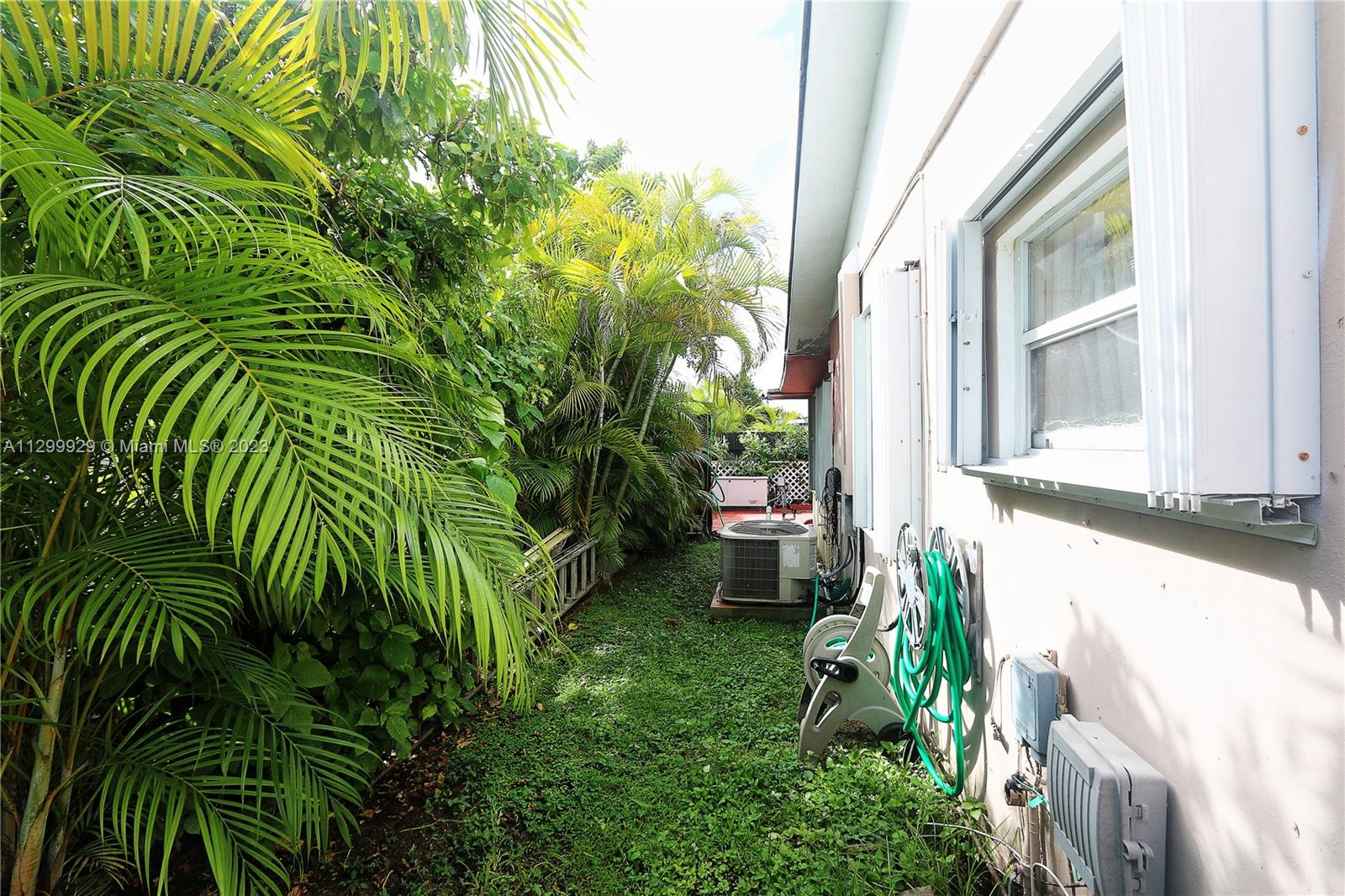 842 Southwest 89th Avenue, Unit A Miami, FL 33174 - Photo 33 of 34 a backyard of a house with outdoor seating and plants