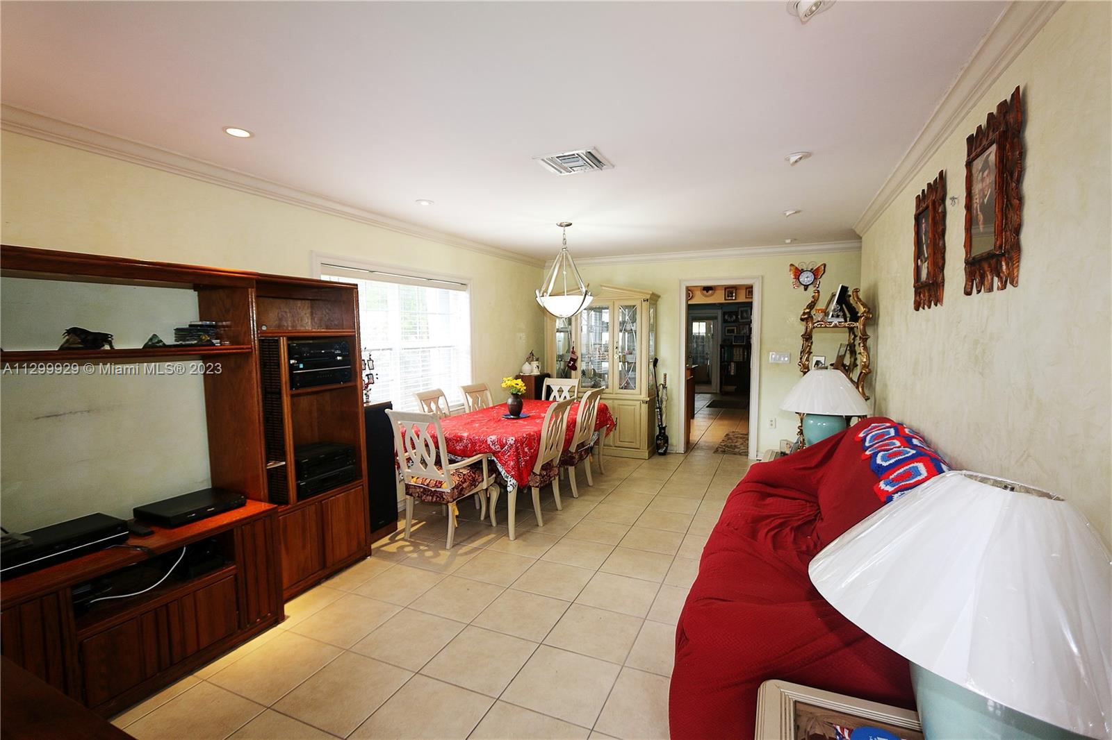 842 Southwest 89th Avenue, Unit A Miami, FL 33174 - Photo 5 of 34 a living room with furniture a flat screen tv and a refrigerator