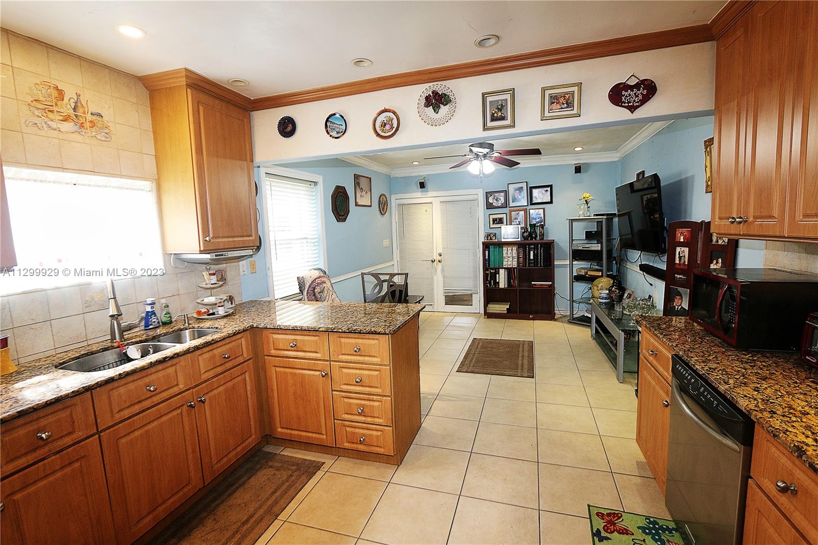 842 Southwest 89th Avenue, Unit A Miami, FL 33174 - Photo 8 of 34 a kitchen with stainless steel appliances granite countertop a sink and cabinets