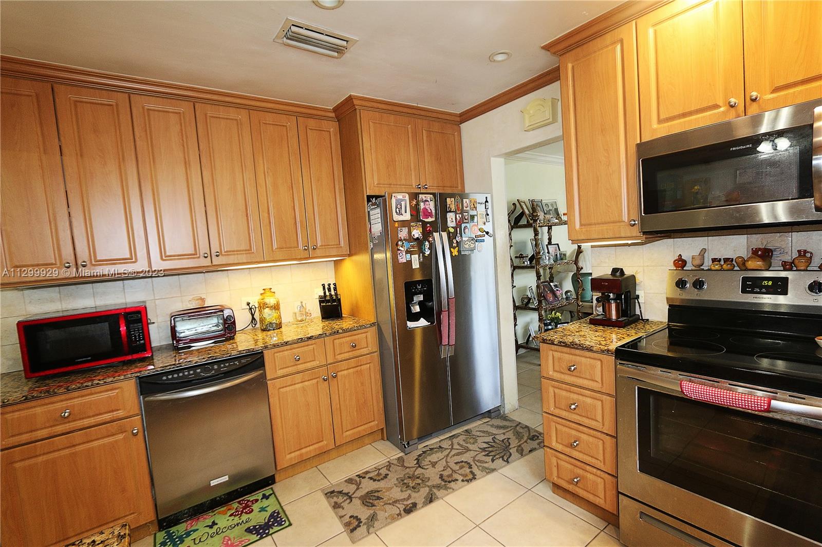 842 Southwest 89th Avenue, Unit A Miami, FL 33174 - Photo 10 of 34 a kitchen with stainless steel appliances a stove microwave and refrigerator