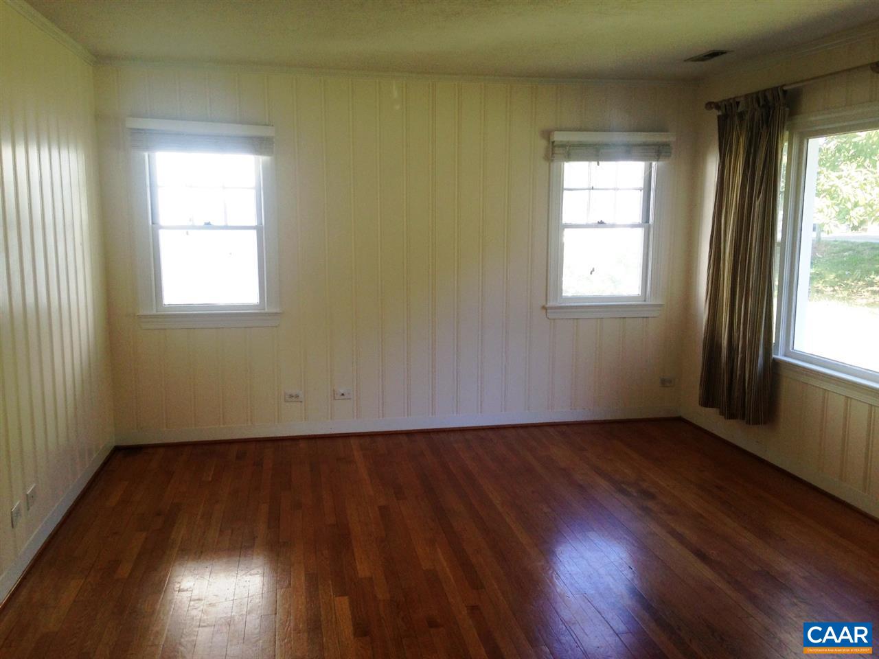 219 Shamrock Road Charlottesville, VA 22903 - Photo 2 of 12 an empty room with wooden floor and windows
