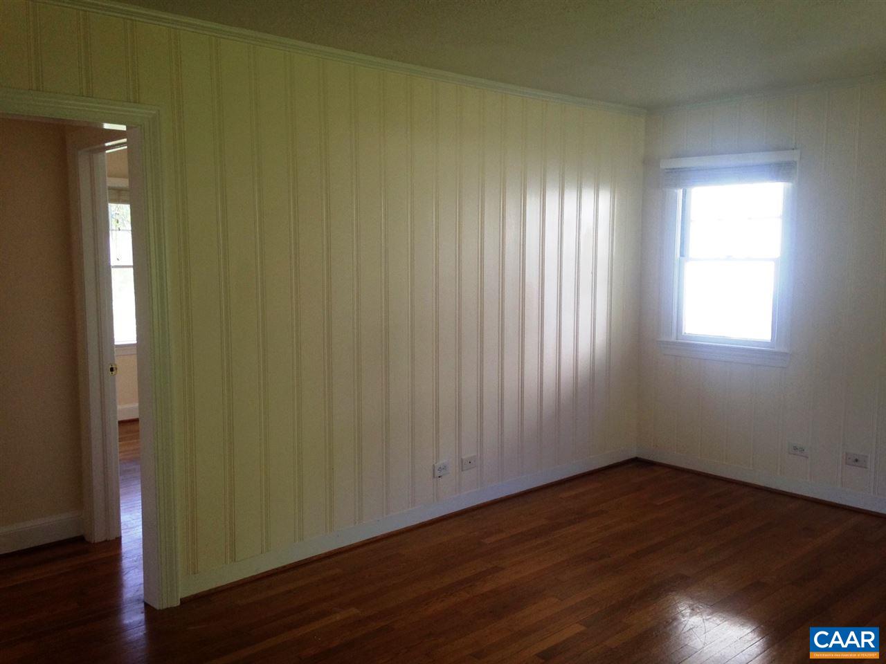 219 Shamrock Road Charlottesville, VA 22903 - Photo 3 of 12 an empty room with wooden floor and windows